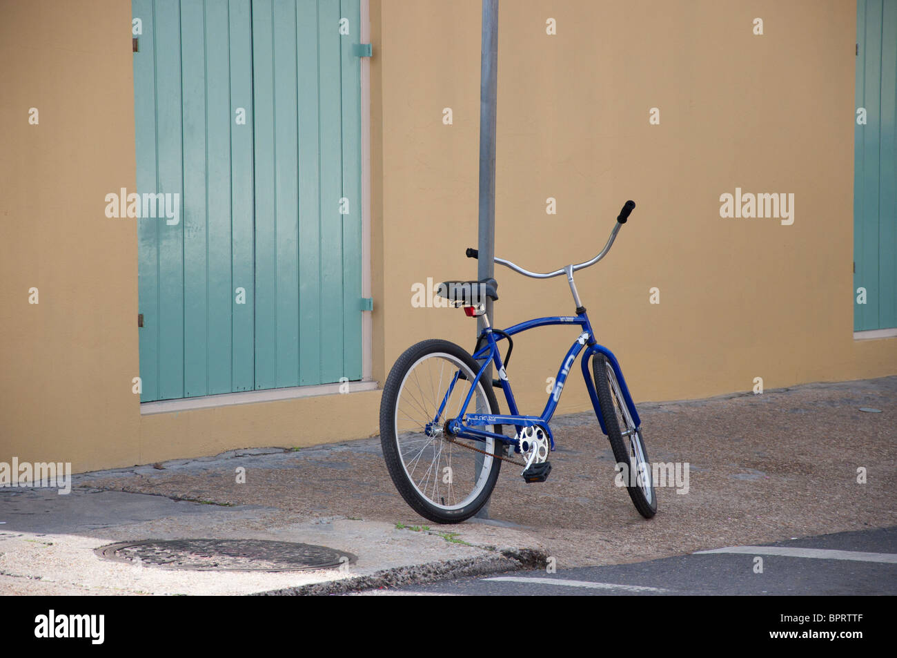 blue bicycle parked on sidewalk Stock Photo