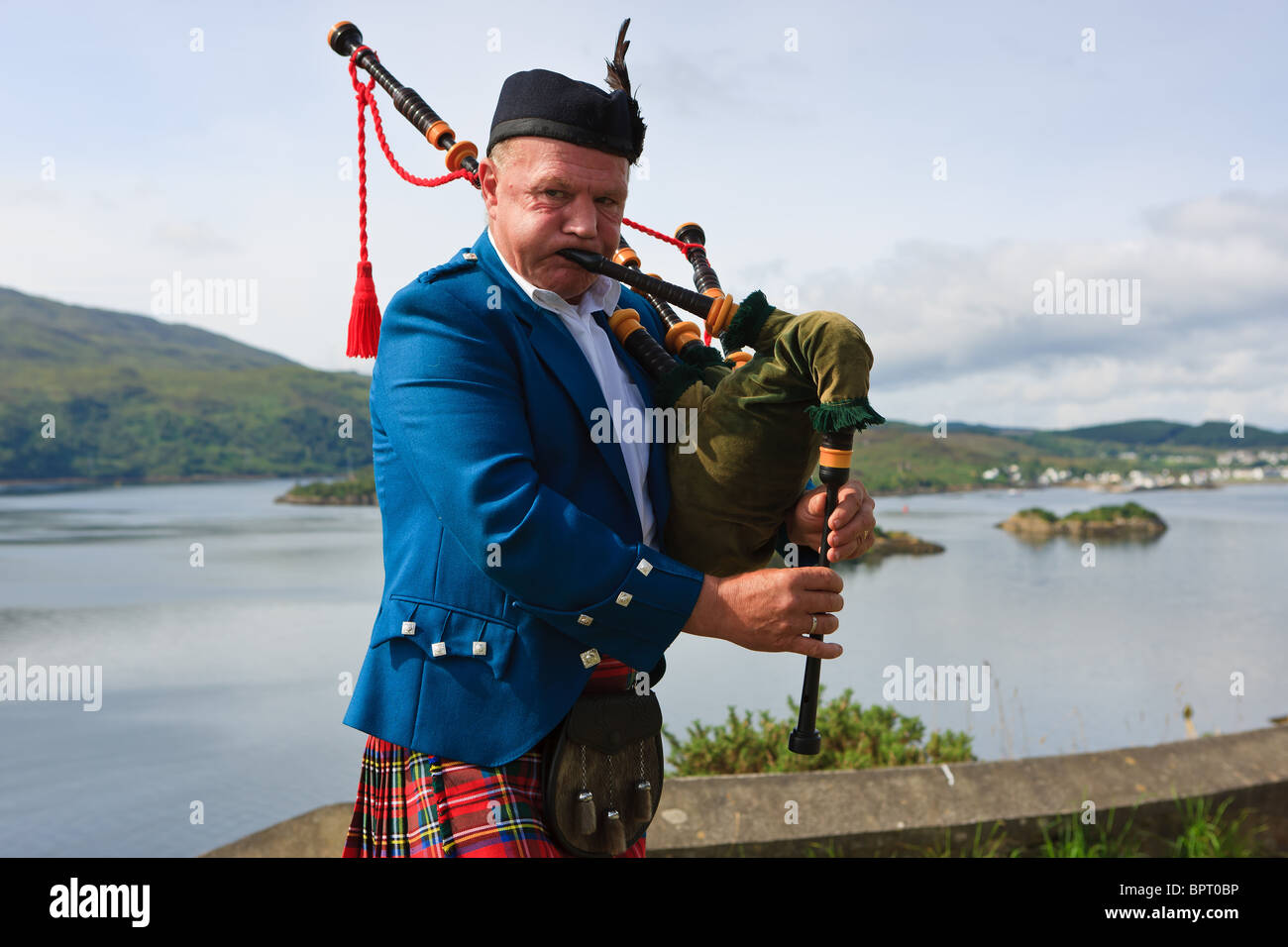 Bagpipe player on the Scottish Highlands, near the Isle of Skye Stock