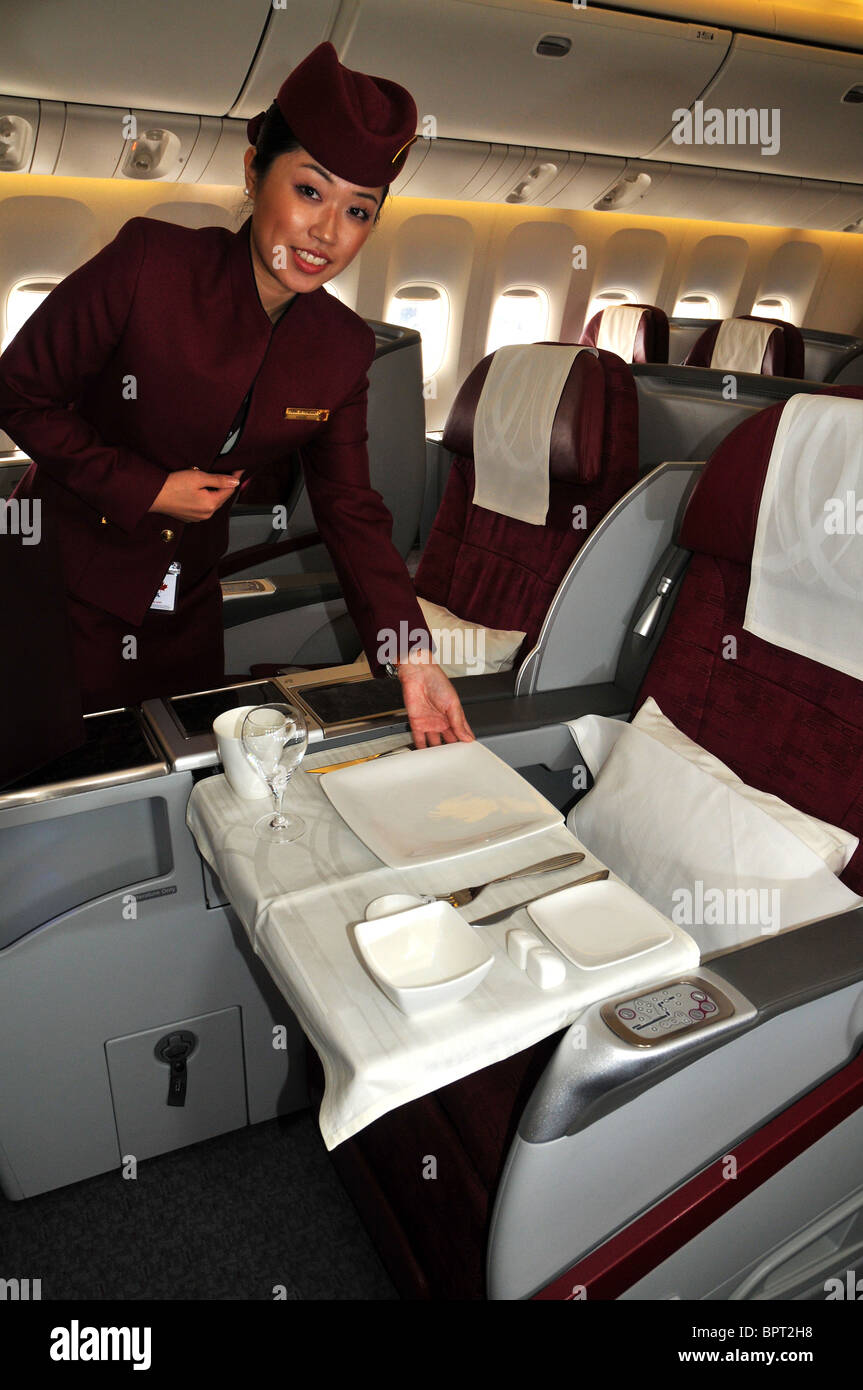 Qatar airlines stewardess in first and business class Stock Photo