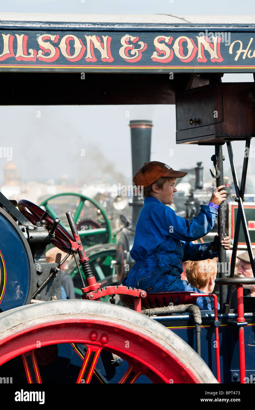 Young Boy sitting on a Showmans Traction Engine at Great Dorset steam fair 2010, England Stock Photo