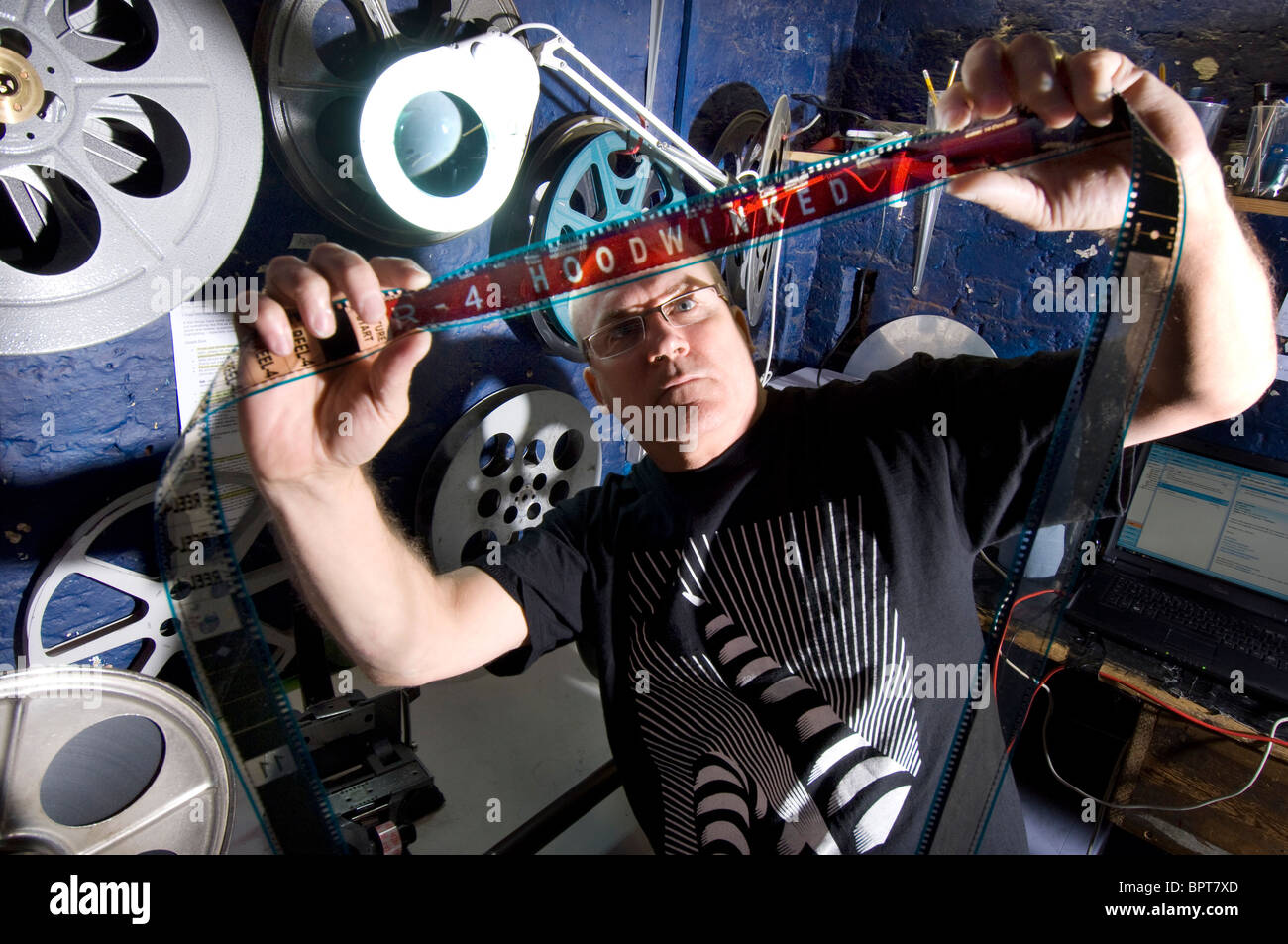 The projectionist of the Duke of Yorks cinema, Brighton, UK sets up a 35mm film. Stock Photo