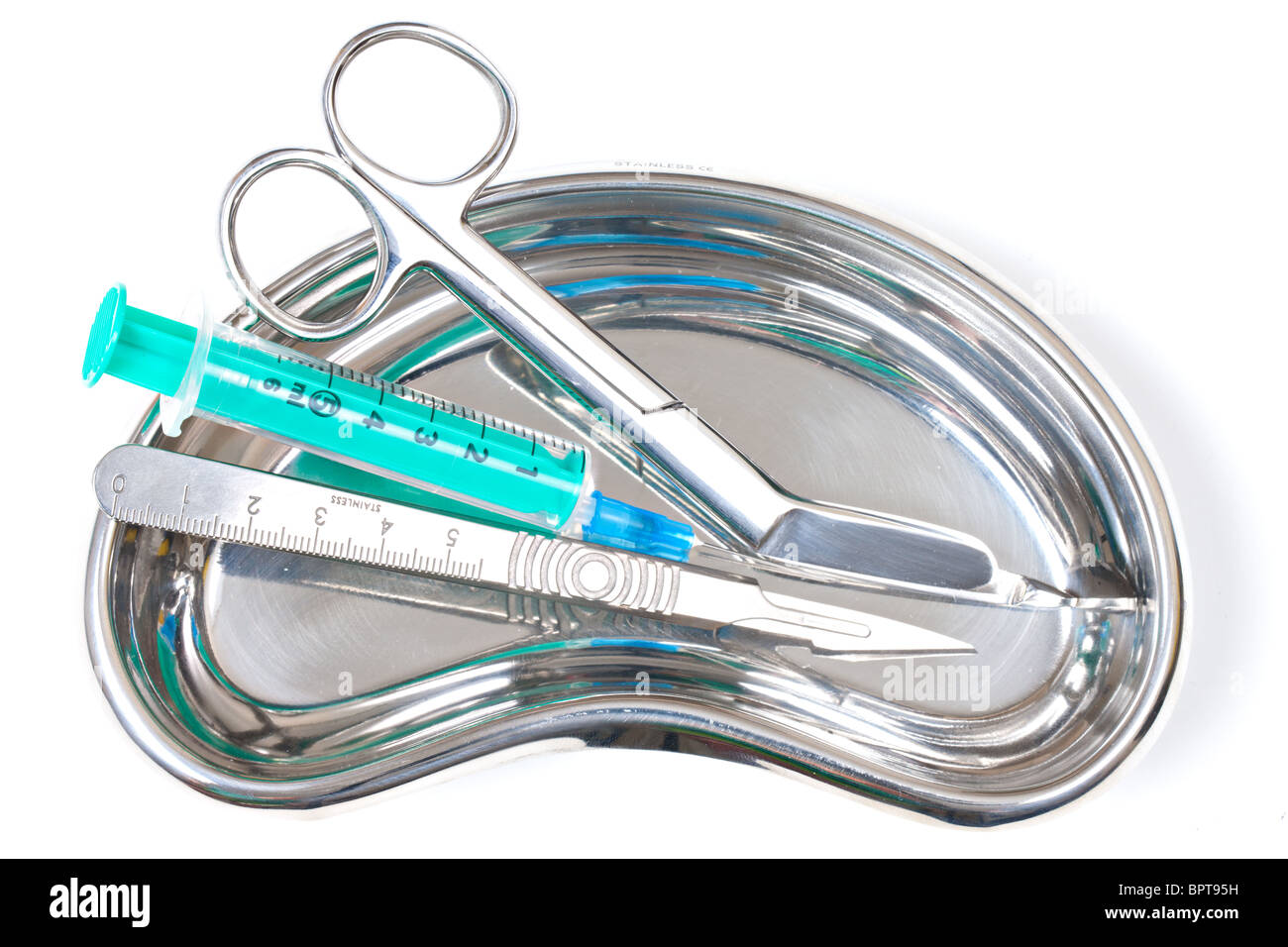 Scalpel and Scissors and syringe in stailess steel kidney dish Stock Photo