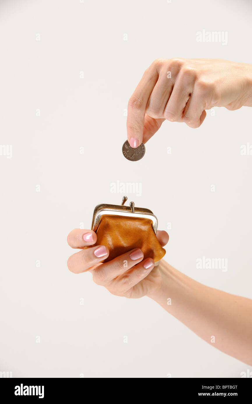 woman puts quarter into coin purse Stock Photo Alamy