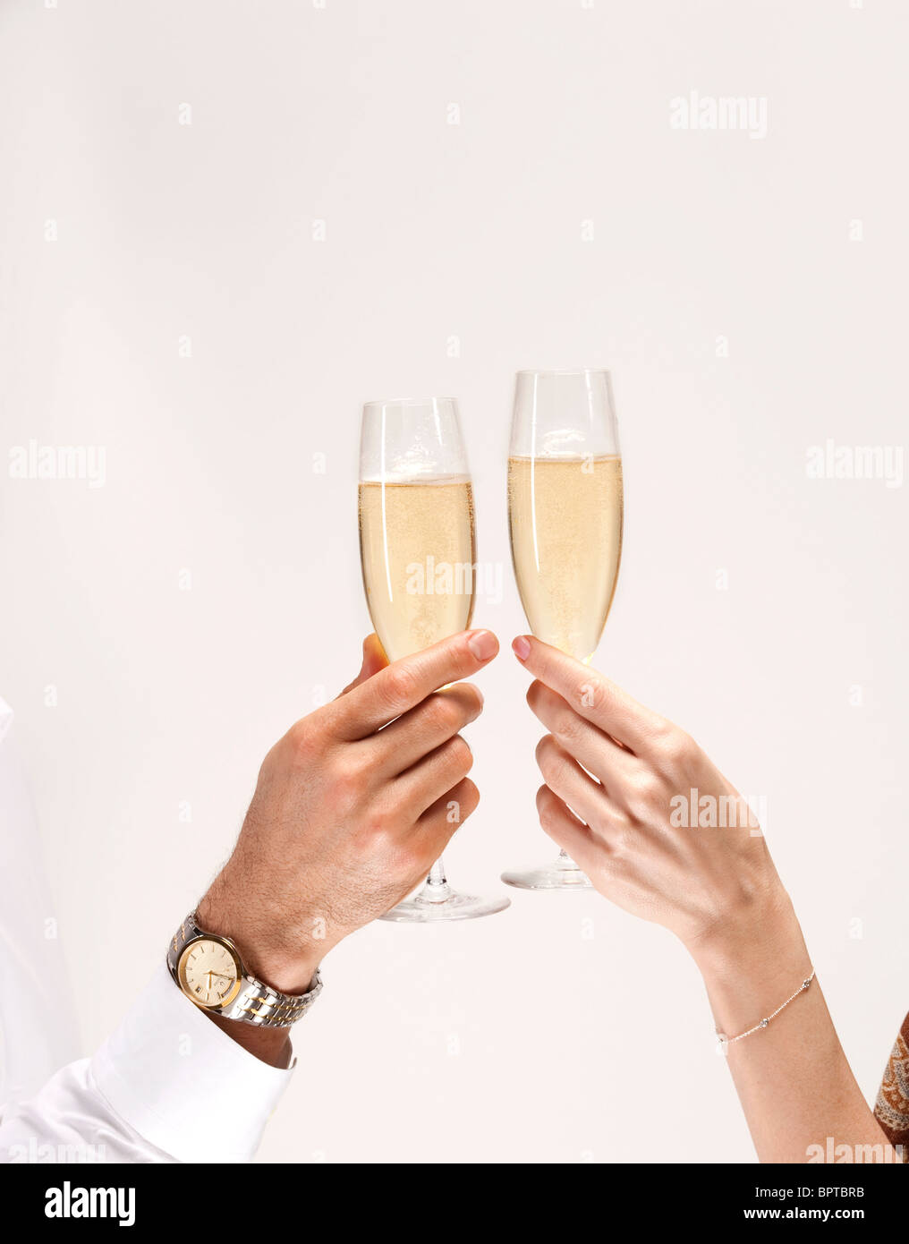 couple's hands toast with glasses of champagne Stock Photo
