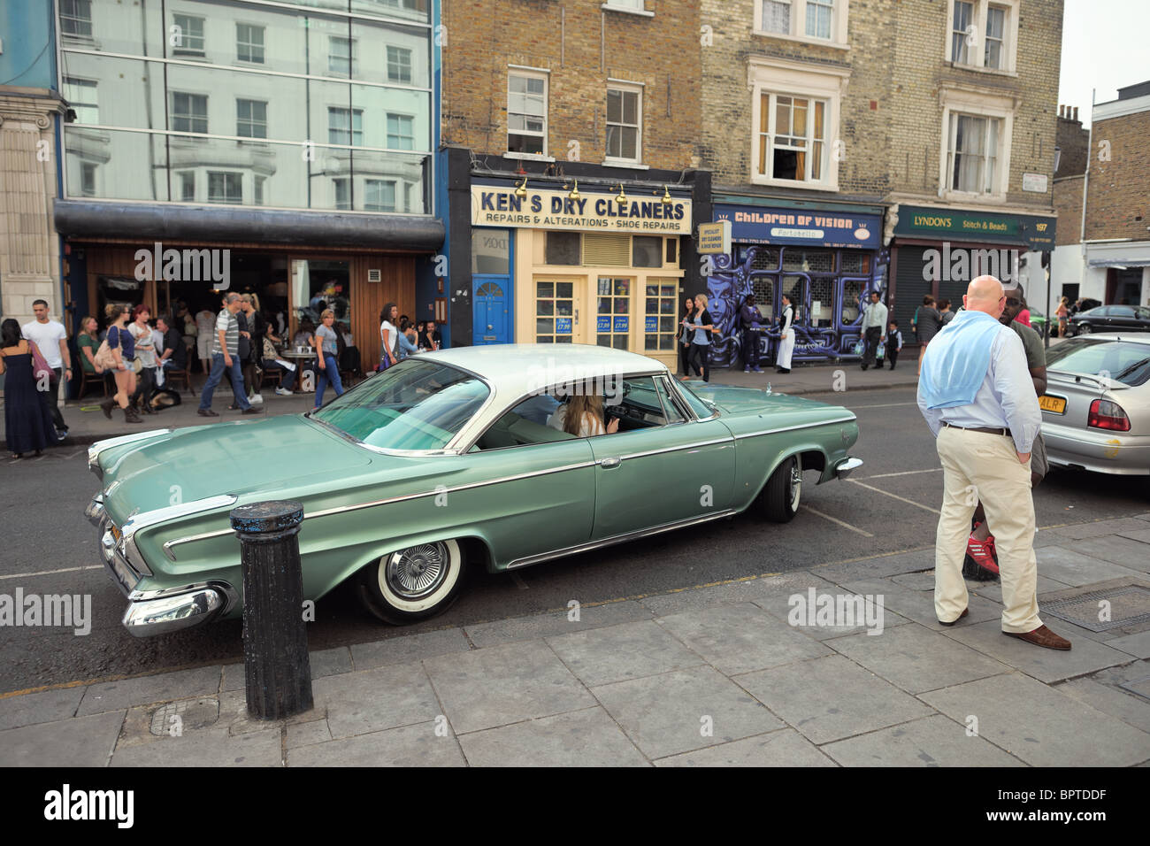 Big American classic car (Dodge) with distinctive rear lights pulling out on the fashionable Portobello Road, London, England, Stock Photo