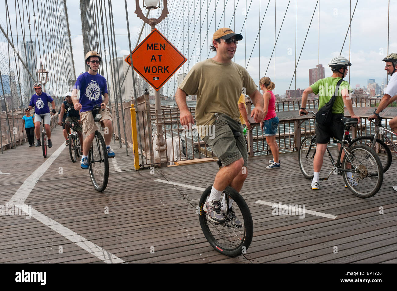 Unicyclists ride across the Brooklyn Bridge for the Brooklyn Long