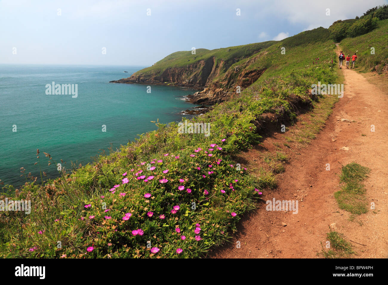 A family enjoys the magnificent view along the coastal path of north Herm in the Channel Islands of England. Stock Photo