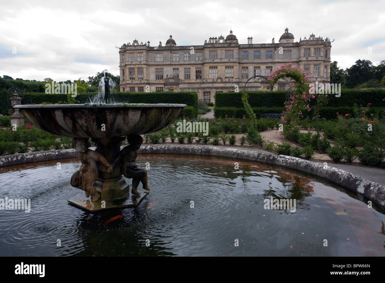 Longleat House showing one of the smaller fountains in the gardens at the side of the house Stock Photo