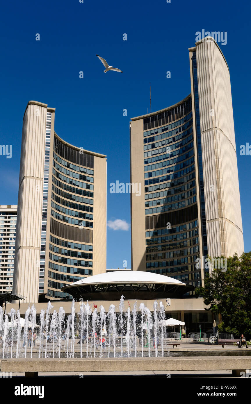 Lunchtime at Nathan Philips Square Toronto City Hall with fountain seagull and blue sky Stock Photo