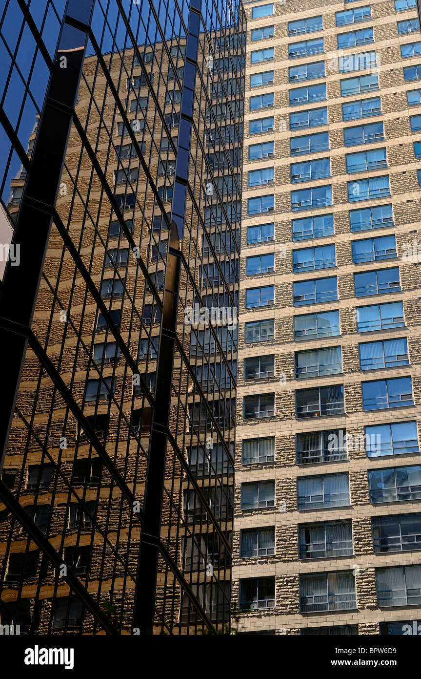 Abstract of stone Condominium reflected in the glass of a high rise office tower Toronto Stock Photo