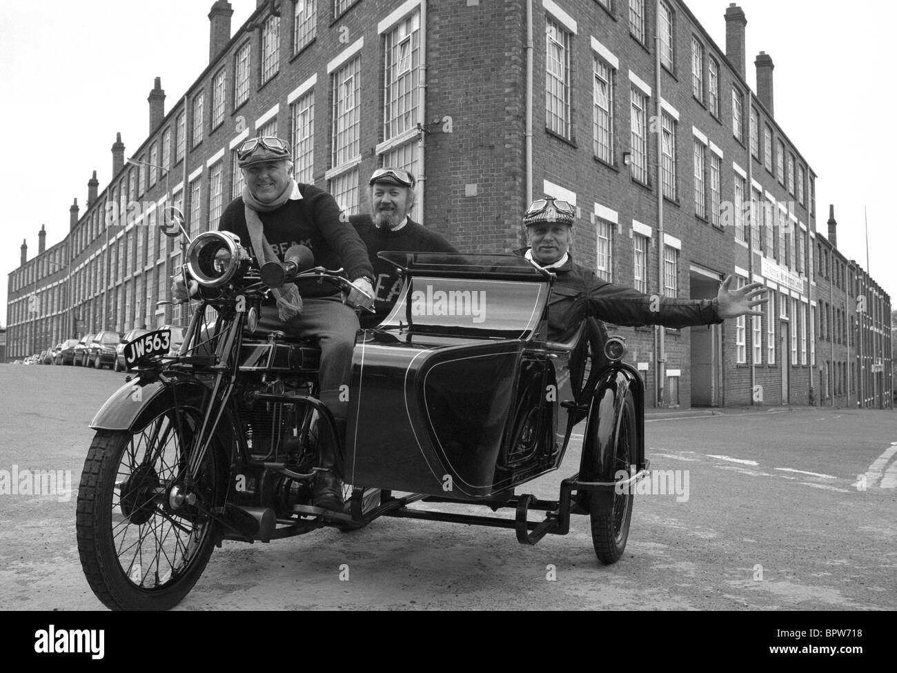 Sunbeam motorcycle enthusiasts riding a Sunbeam motorcycle and sidecar in past the former Sunbeam factory in Wolverhampton Stock Photo