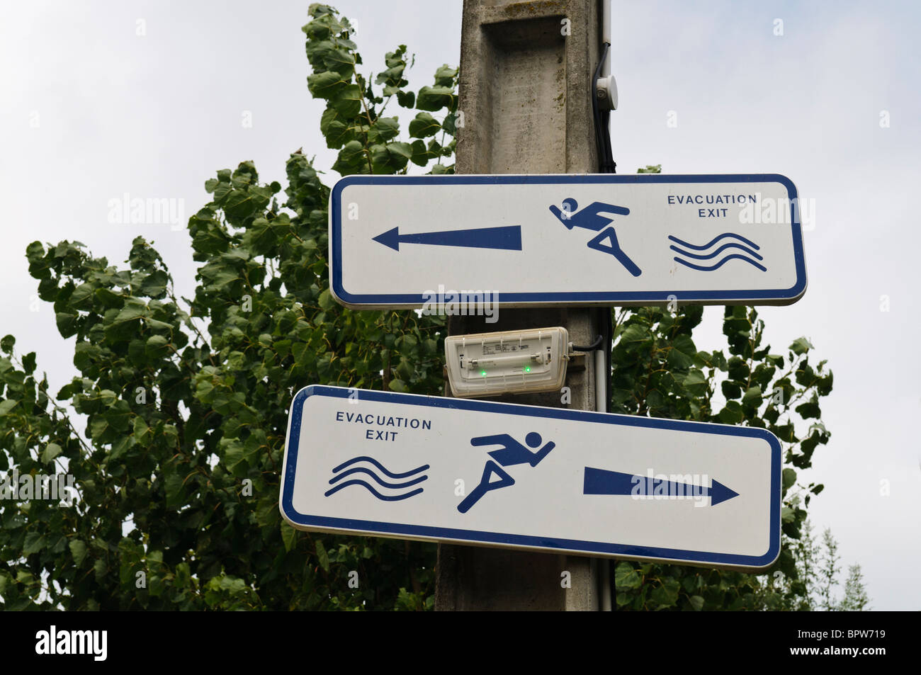 Signs pointing both left and right, indicating evacuation route in the event of flooding. Stock Photo