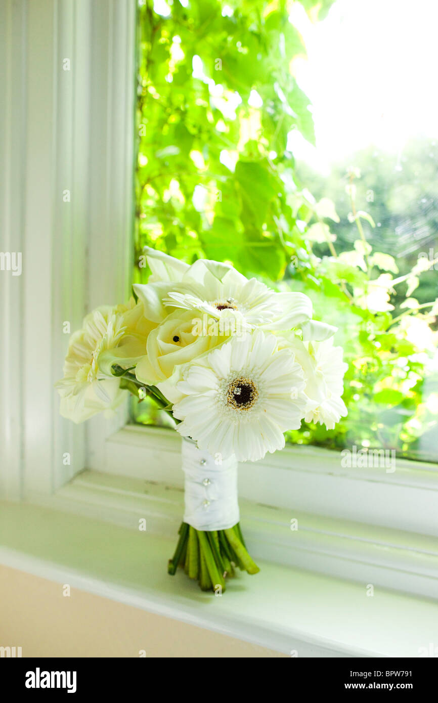 Wedding bouquet on window sill Stock Photo