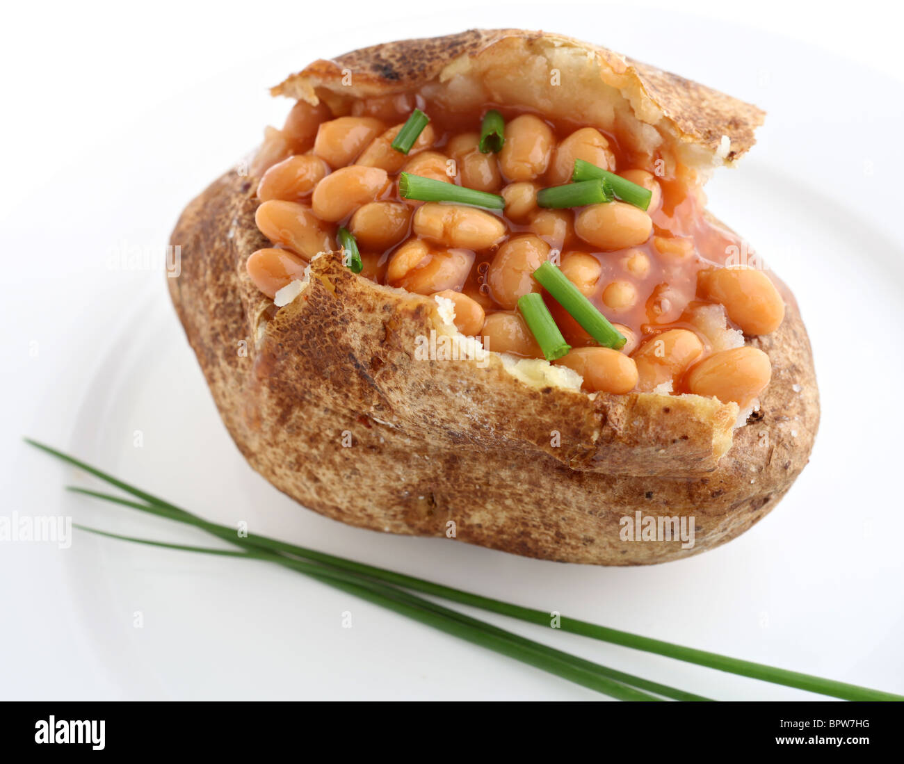 A baked russet burbank (or Idaho) potato stuffed with baked beans and