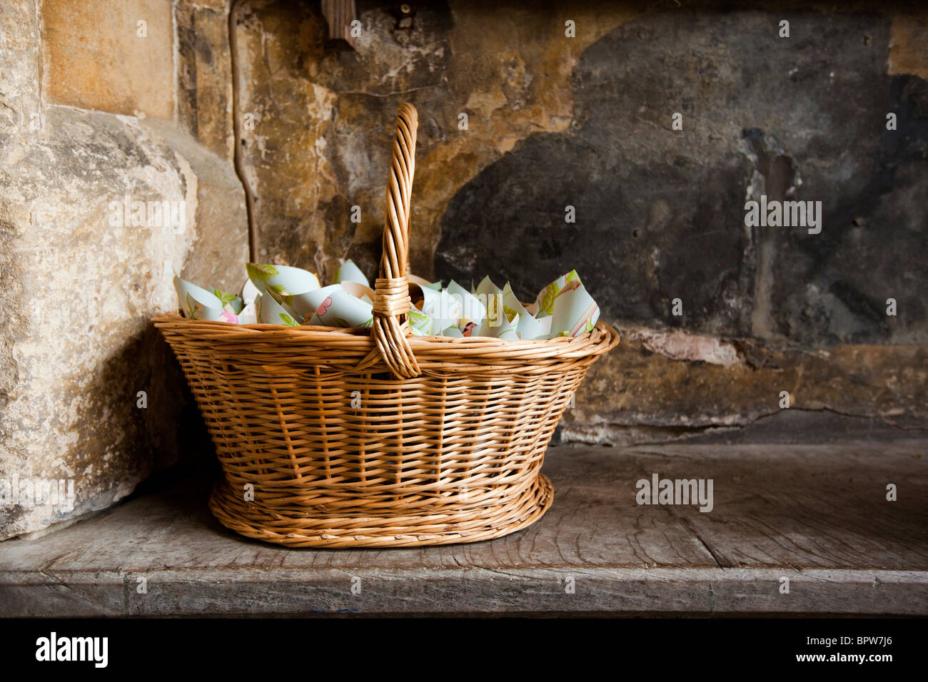 Wedding confetti in basket on church bench Stock Photo