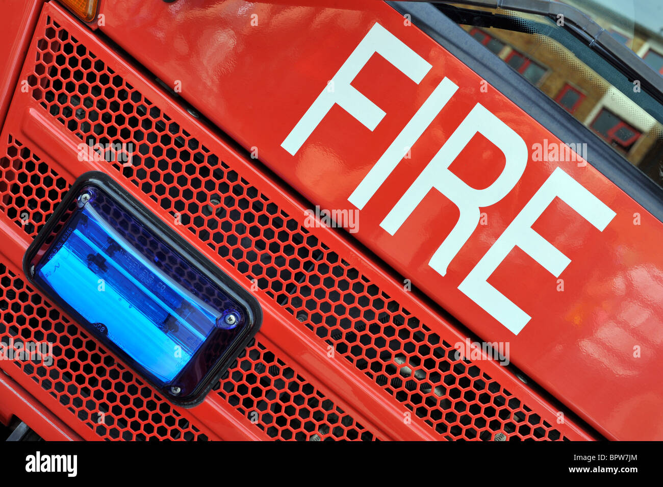 The word 'Fire' emblazoned across the front of a British red fire engine Stock Photo