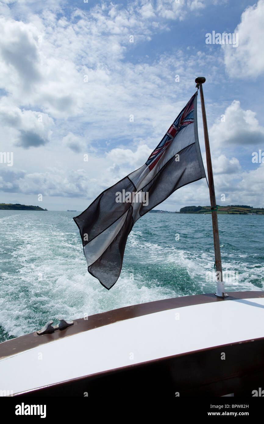 Saint Piran's Flag flying from boat on the River Fal Cornwall Stock Photo