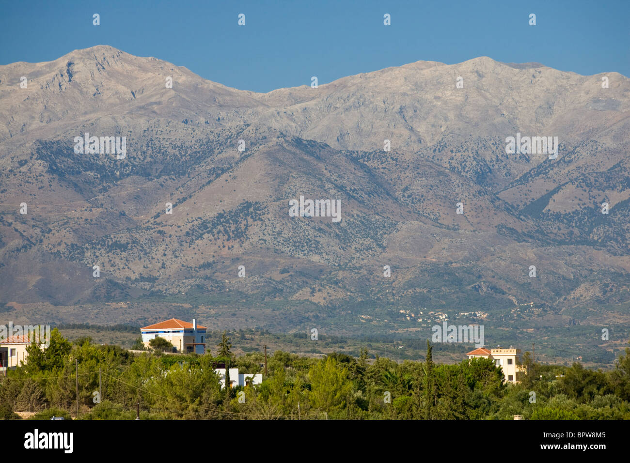 Lefka Ori mountain range and holiday villas, Crete, Greece Stock Photo