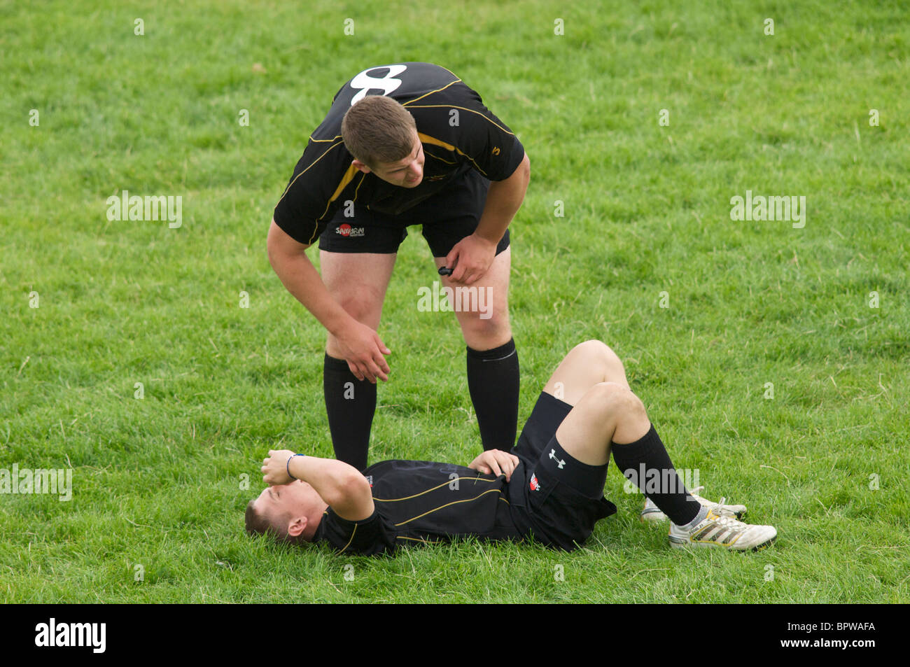 rugby player shoes concern for colleague injured during a match Stock Photo