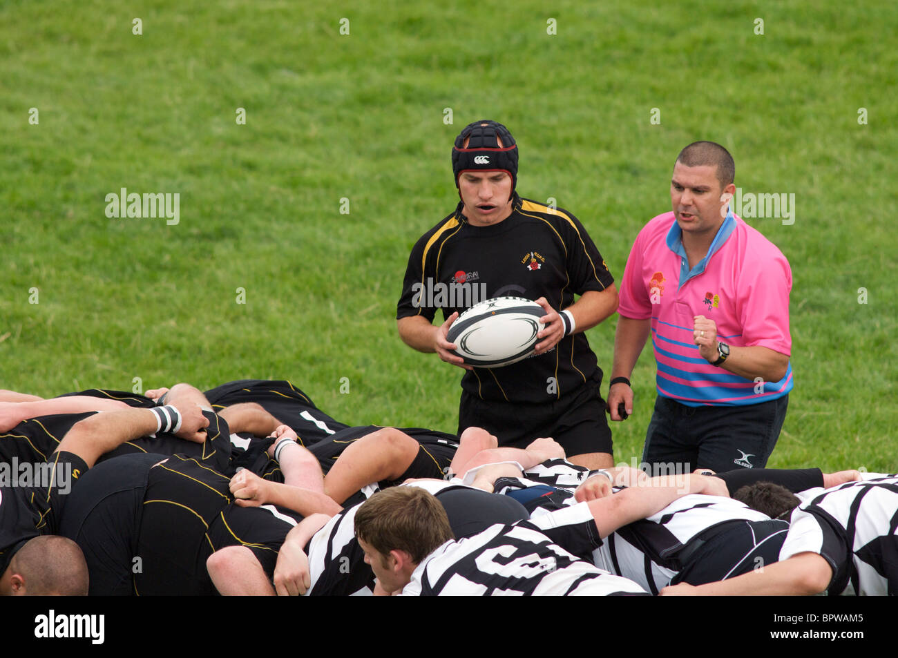 rugby refree gives instruction at scrum Stock Photo