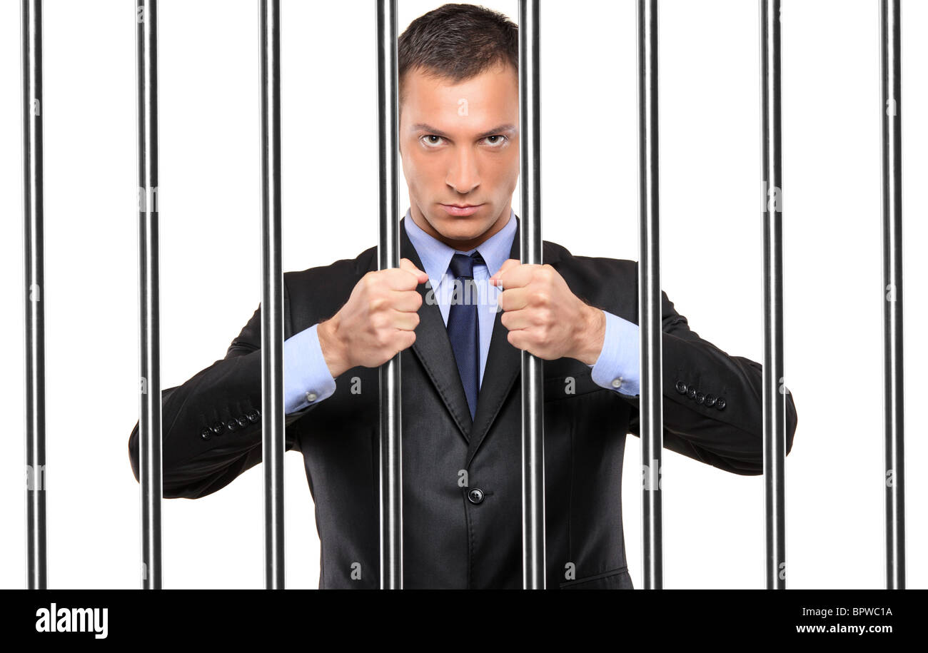 A businessman in jail holding bars Stock Photo Alamy
