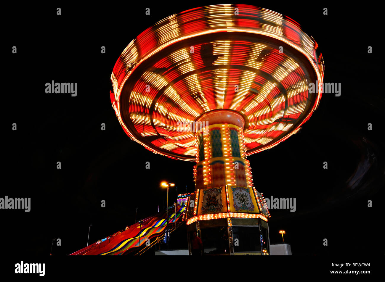 Red and white light streaks at night from the Swing ride at the Toronto Canadian National Exhibition CNE funfair midway fairgrounds Stock Photo