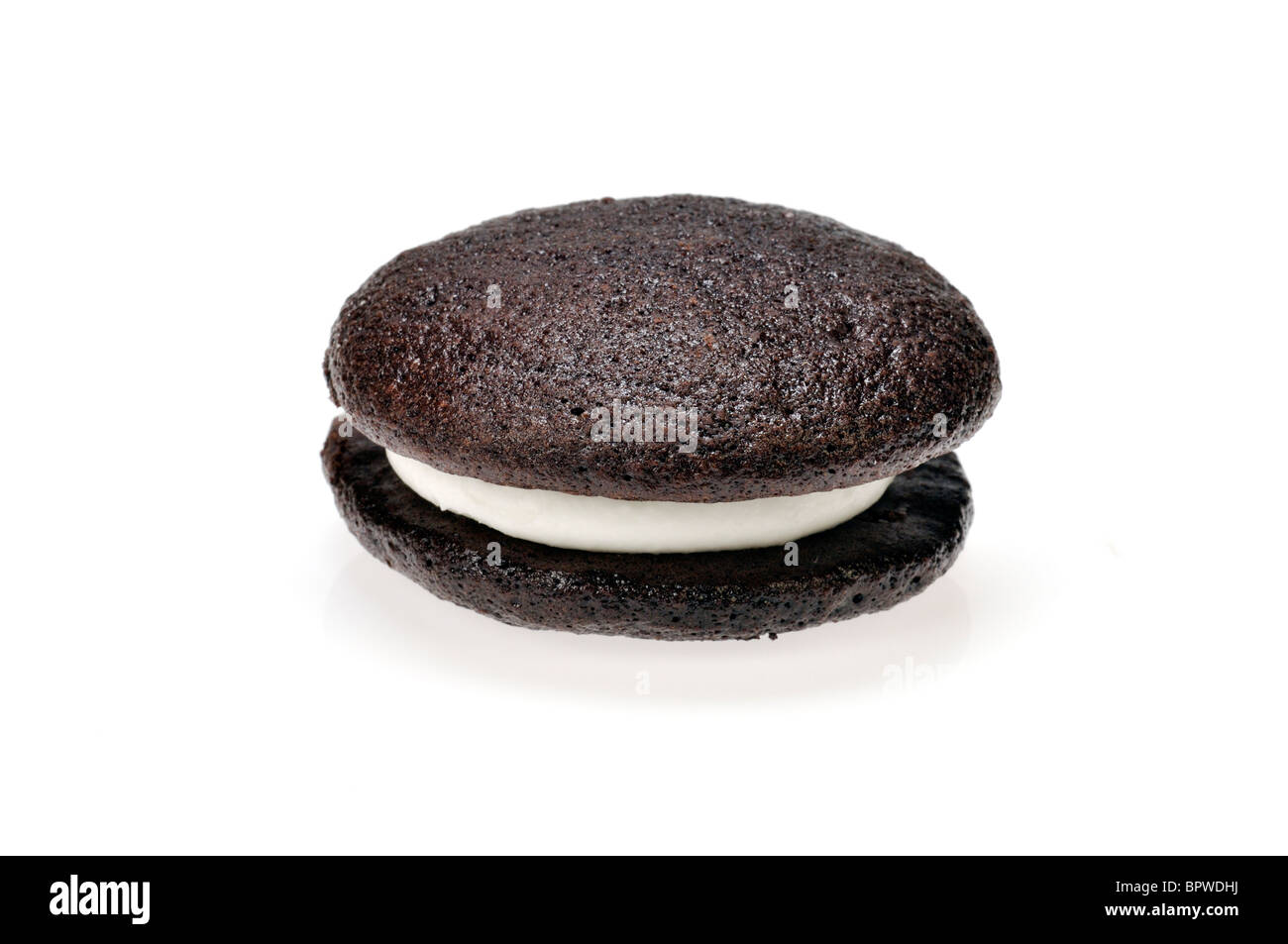 Single whoopie pie vanilla  cream stuffed between 2 chocolate cakes pastry on white background, cutout. Stock Photo