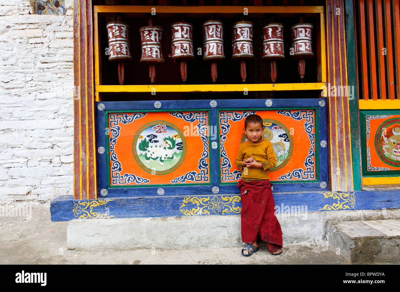 Prayer wheels and child at the Buddhist Labrang Monastery, Sikkim, India Stock Photo