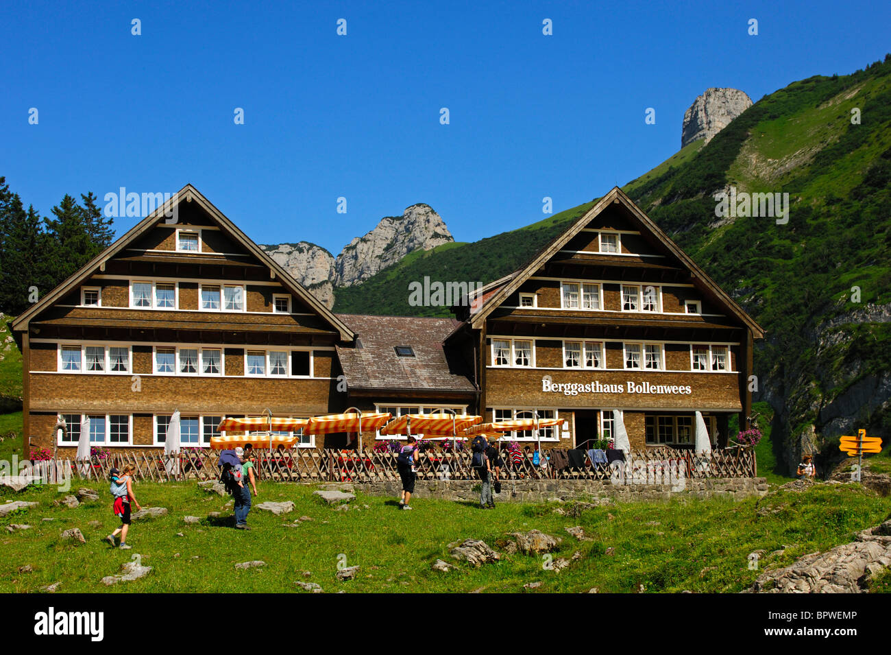 Hikers arriving at the mountain inn Bollenwees, Bruelisau, Alpstein mountain range, canton of Appenzell Innerrhoden, Switzerland Stock Photo