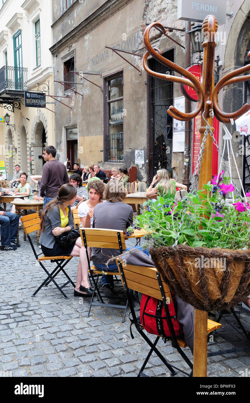 People eating and drinking outdoor at cafe terraces along Bracka St in
