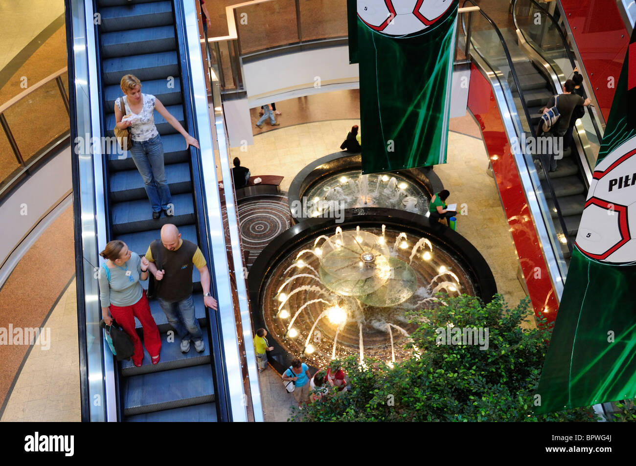 Shoppers and escalators in the Galeria Krakowska, Krakow's biggest shopping centre Kleparz area of Krakow Stock Photo