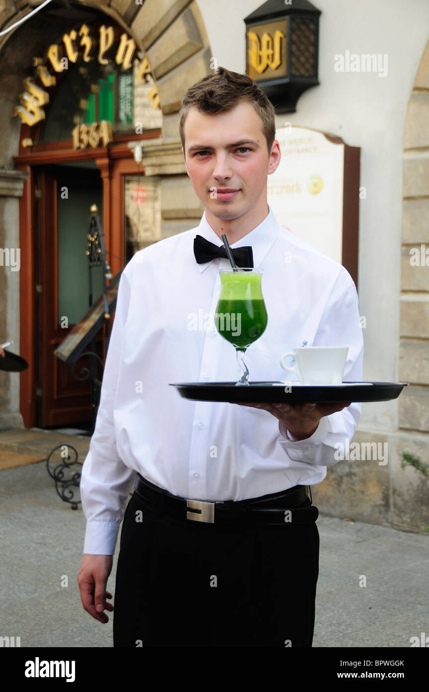 Waiter serving drinks at the Wierzynek Restaurant, in Rynek Glowny, Town Square, in Krakow Stock Photo