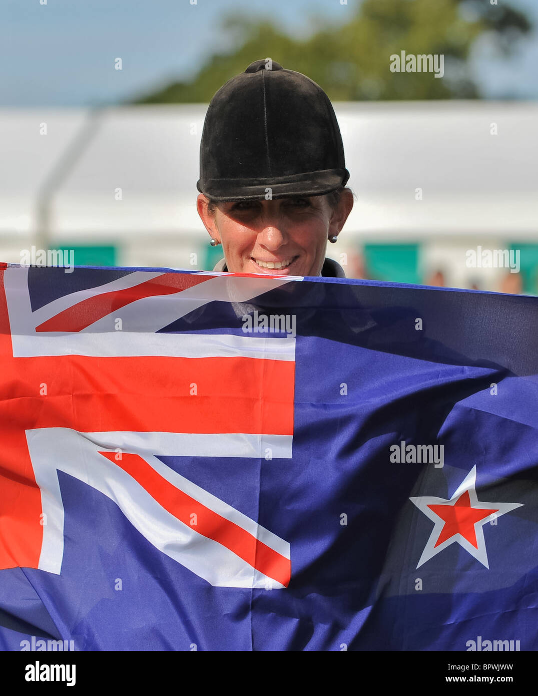 Caroline Powell holds a New Zealand flag after winning the Land Rover Burghley Horse Trials 2010. Stamford, England/ 05/09/2010 Stock Photo