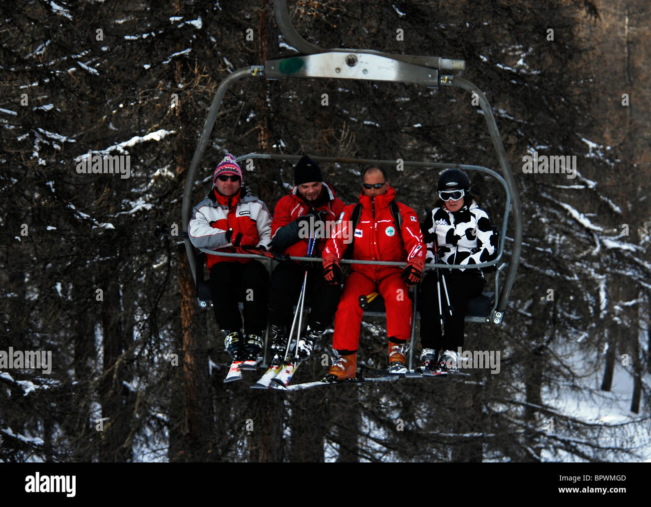 Winter sport. Skiing Sauze D'Oulx, Italy. Skiers ascend the Sportina chairlift. Stock Photo