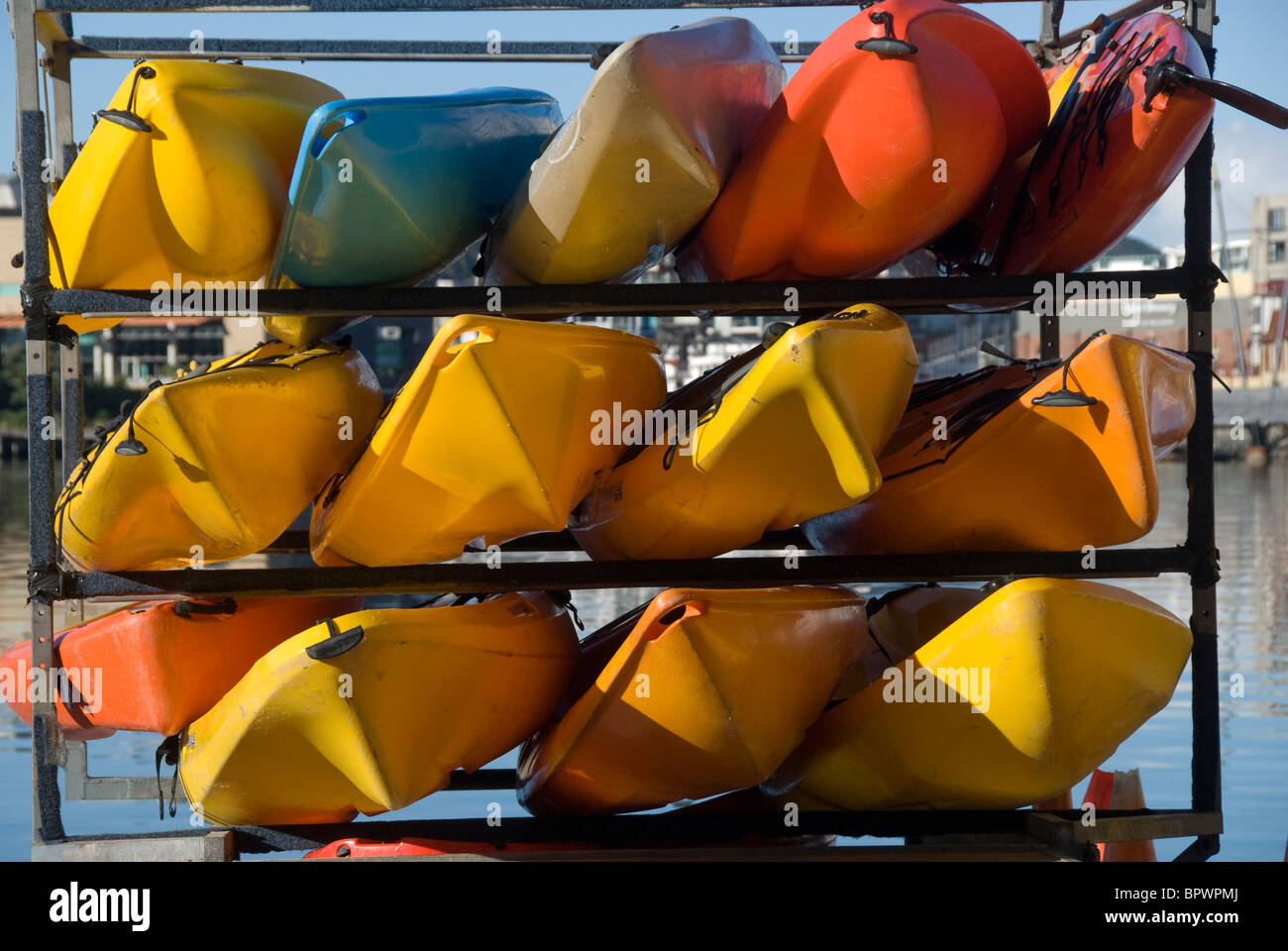 Orange and yellow kayaks stored in racks, Wellington, North Island, New Zealand Stock Photo