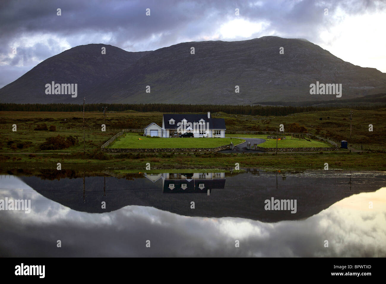 Water Reflection of Home, Connemara County Galway Ireland Stock Photo