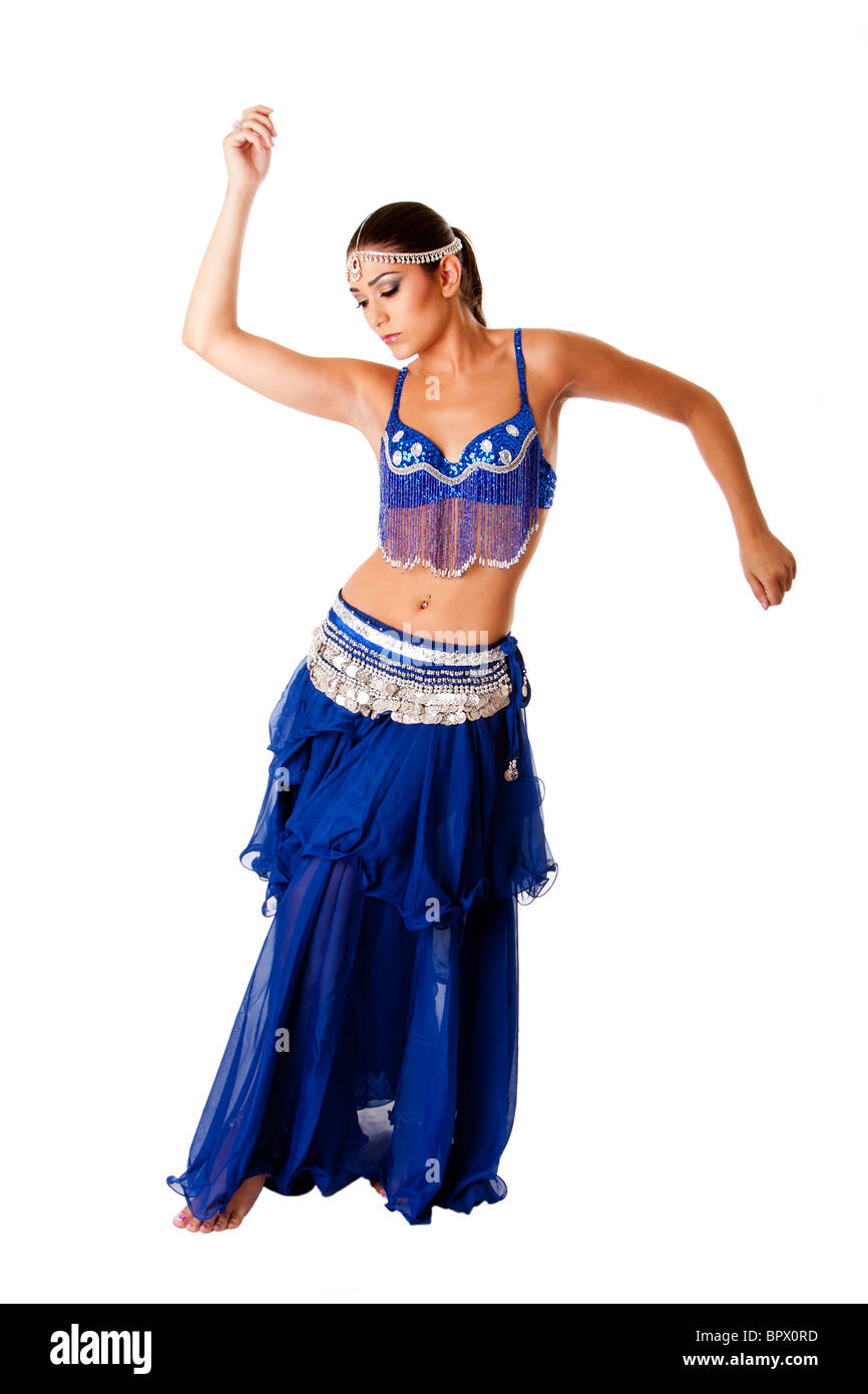 Arabic belly dancer harem woman in blue with silver dress and head jewelry with gem dancing twirling her arms Stock Photo
