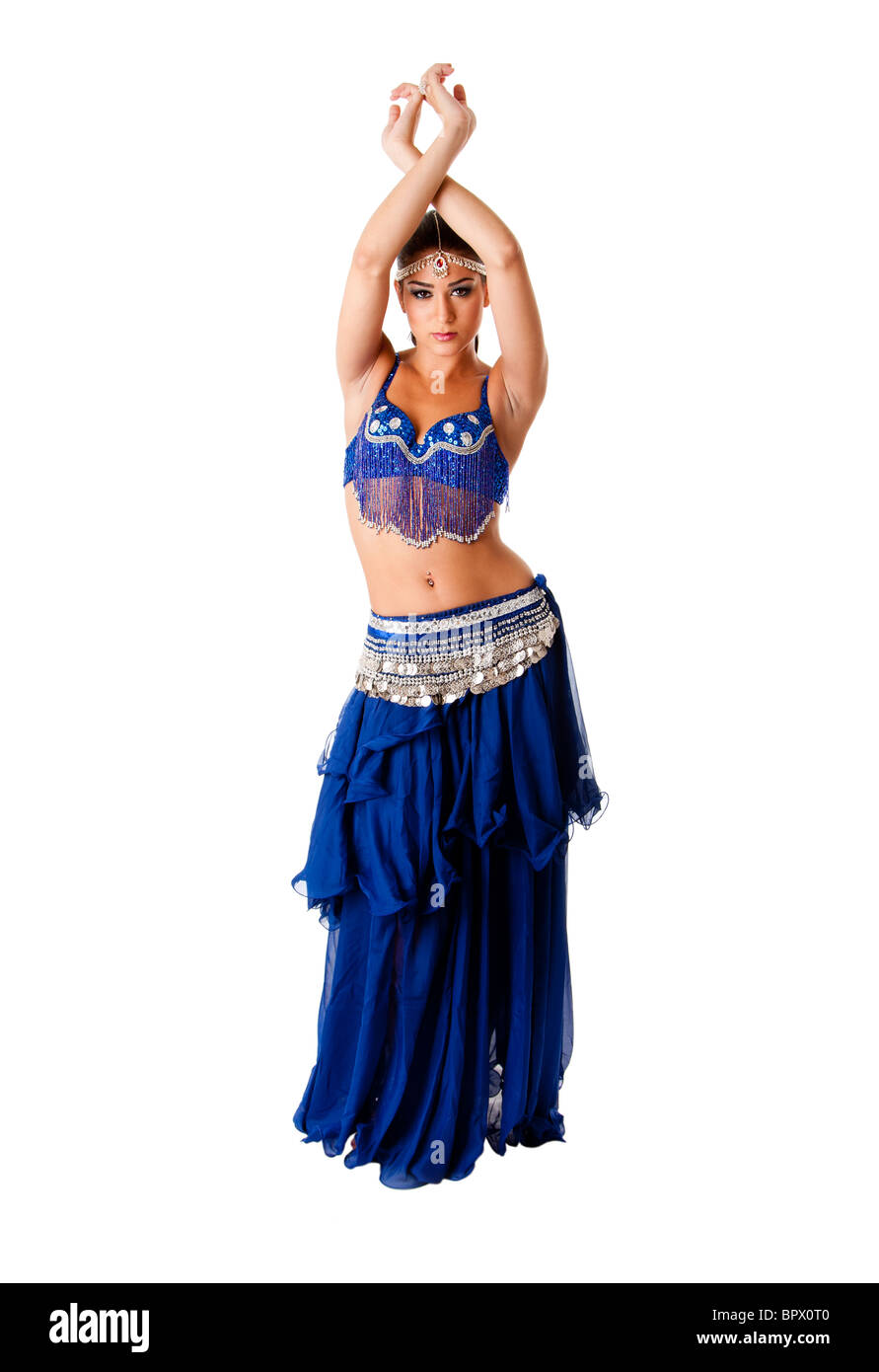 Beautiful Arabic belly dancer harem woman in blue with silver dress and head jewelry with gem dancing arms in air, isolated. Stock Photo
