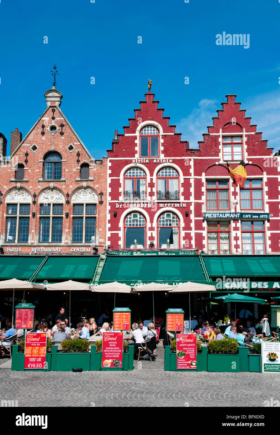 Row of ornate historic buildings and restaurants in Market Square in Bruges in Belgium Stock Photo