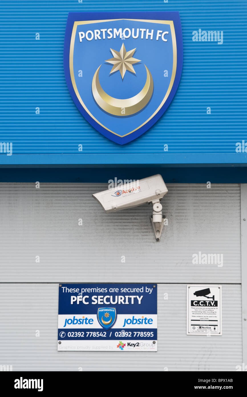 Portsmouth football club logo / sign / motif and showing the cctv camera recording attending fans at the football match. PFC Stock Photo
