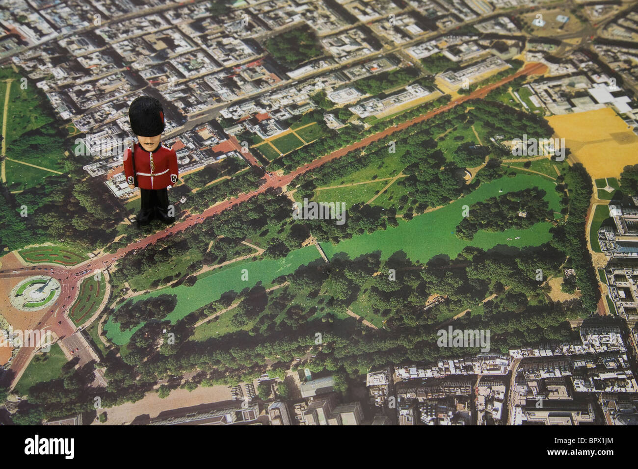 Mini Royal Guardsman Figurine on top of a Aerial View map of Buckingham palace and St james's park Stock Photo