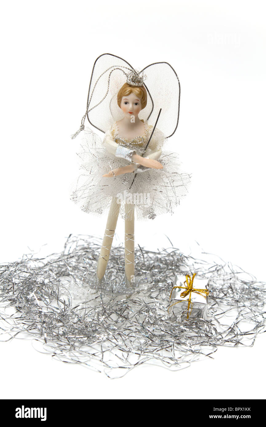 White and silver Christmas fairy with tinsel and a tiny boxed gift Stock Photo