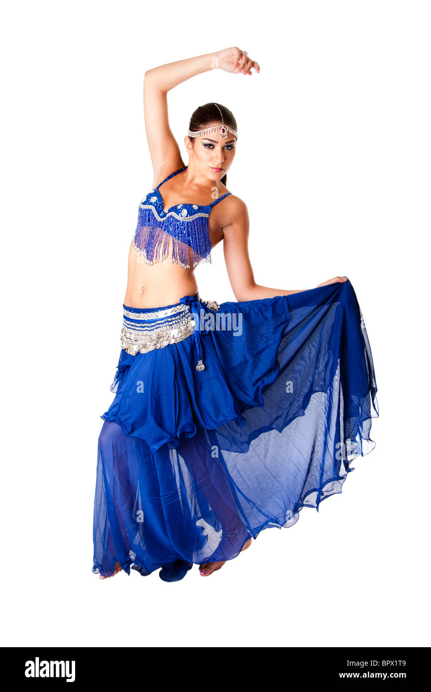 Beautiful Arabic belly dancer harem woman in blue with silver dress and head jewelry with gem dancing holding skirt, isolated. Stock Photo