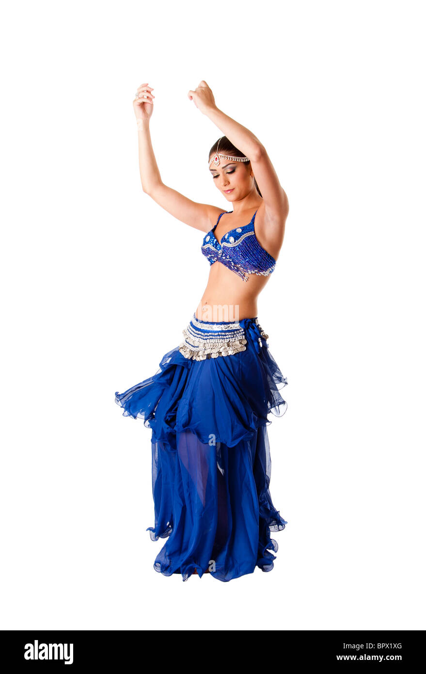 Beautiful Arabic belly dancer harem woman in blue with silver dress and head jewelry with gem dancing swirling skirt, isolated. Stock Photo