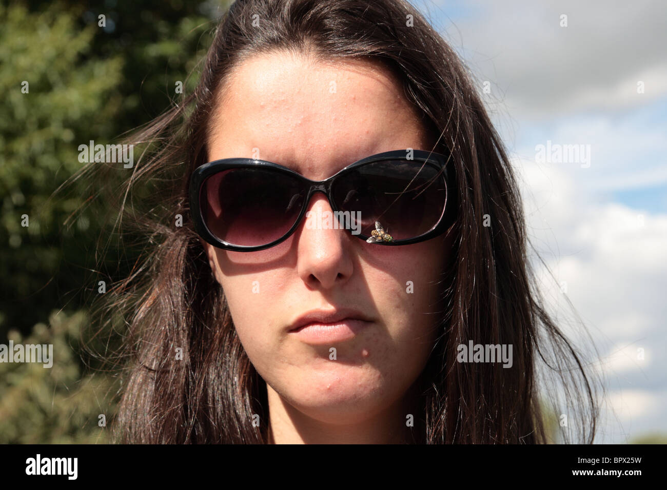 Girl with deer fly on sunglasses Stock Photo