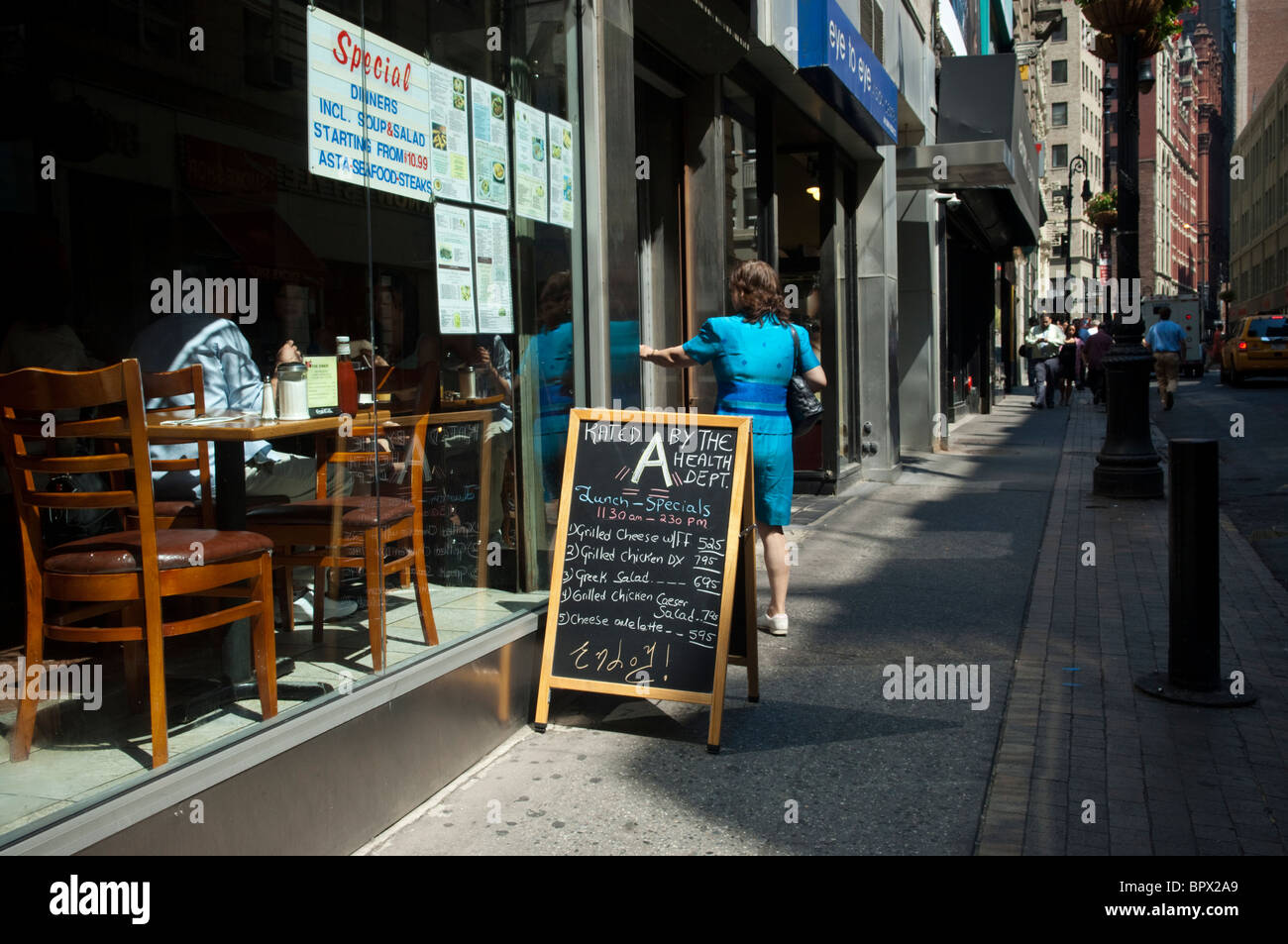 A restaurant in lower Manhattan proudly announces its A grade from the