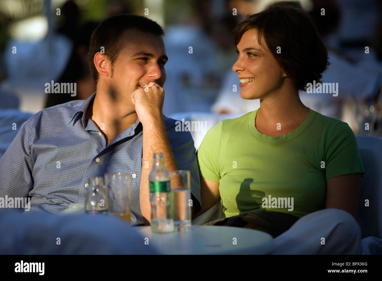 A couple enjoy drinks at a cafe in the late afternoon sun at the Sarajevo Film Festival, Sarajevo, Bosnia Stock Photo
