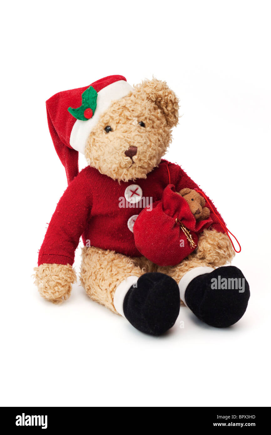 Christmas Teddy. Well loved child's teddy bear dressed as Santa Claus. Stock Photo