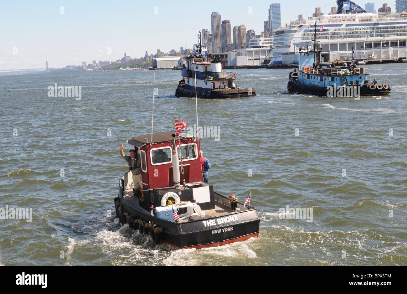 Tugboats on the Hudson River pass the Manhattan cruise ship terminal. Stock Photo