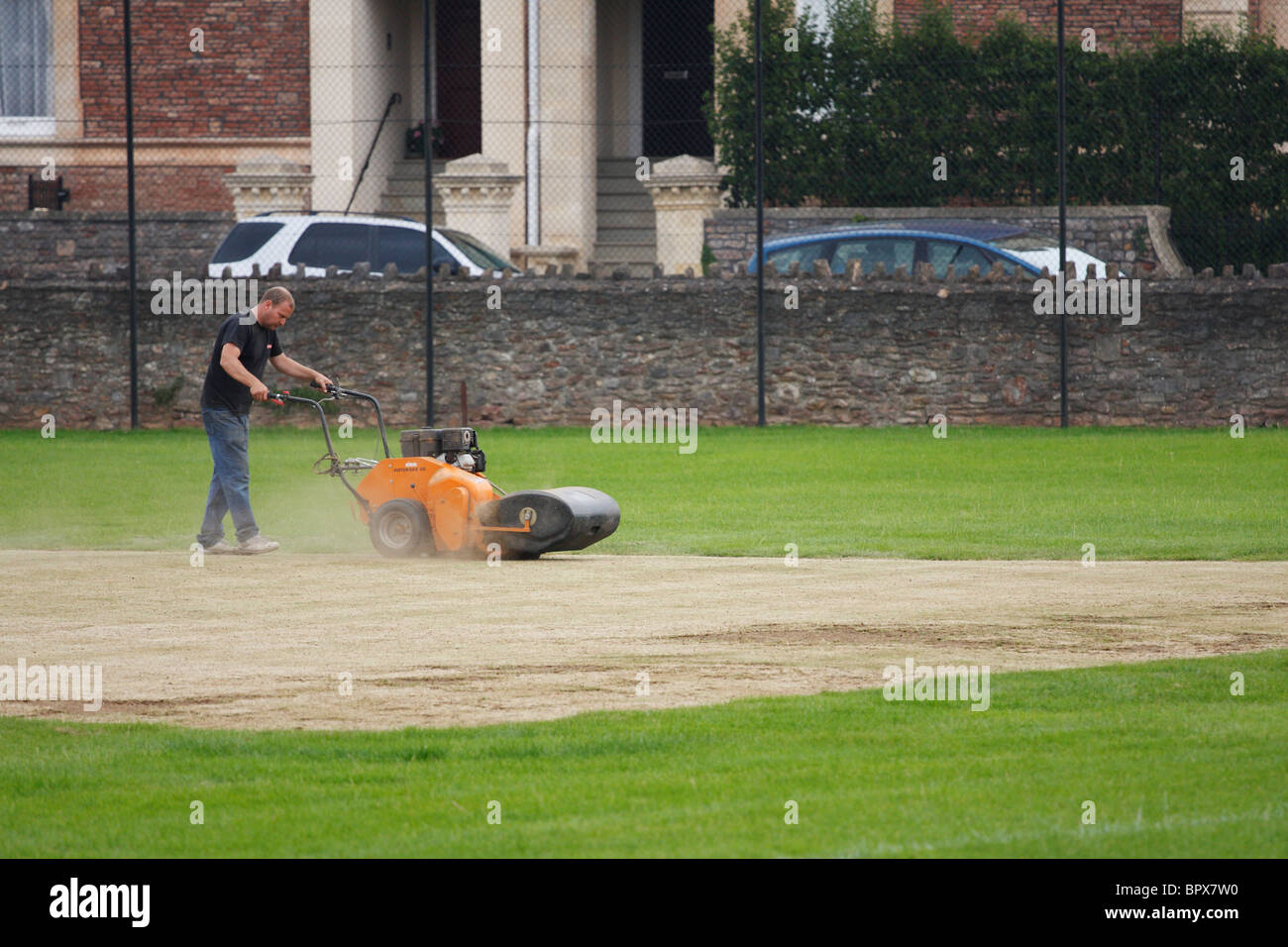Groundsman tending to the cricket pitch Stock Photo Alamy